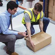 Manager giving safety training to warehouse worker